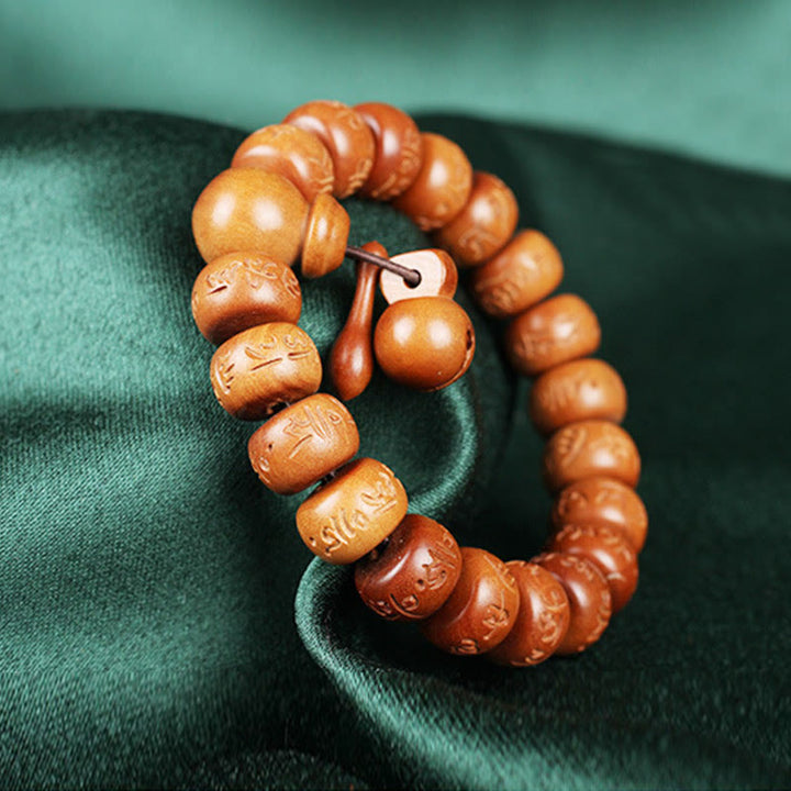 Buddha Stones Armband aus natürlichem tibetischem Pfirsichholz mit Om Mani Padme Hum-Gravur zur Abwehr böser Geister