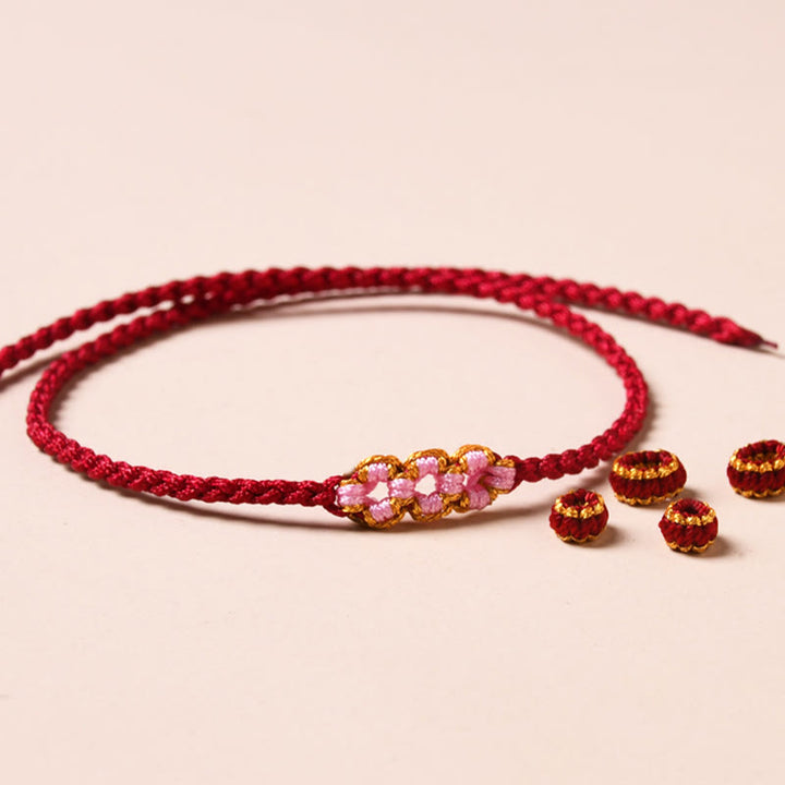 Buddha Stones Handgemachtes Pfirsichblüten-Schutzarmband aus geflochtenem Seil