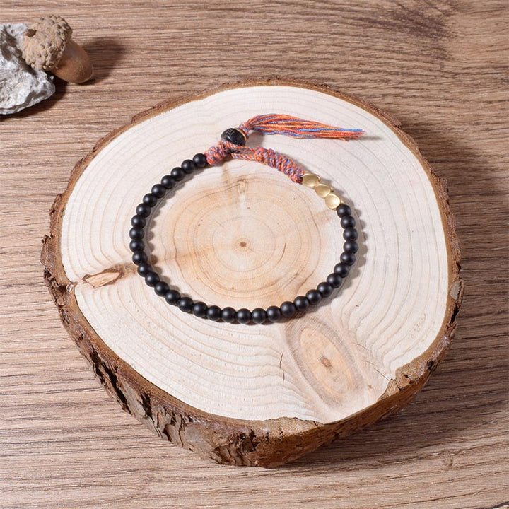 Buddha Stones Handgefertigtes tibetisches schwarzes Onyx-Quastenarmband