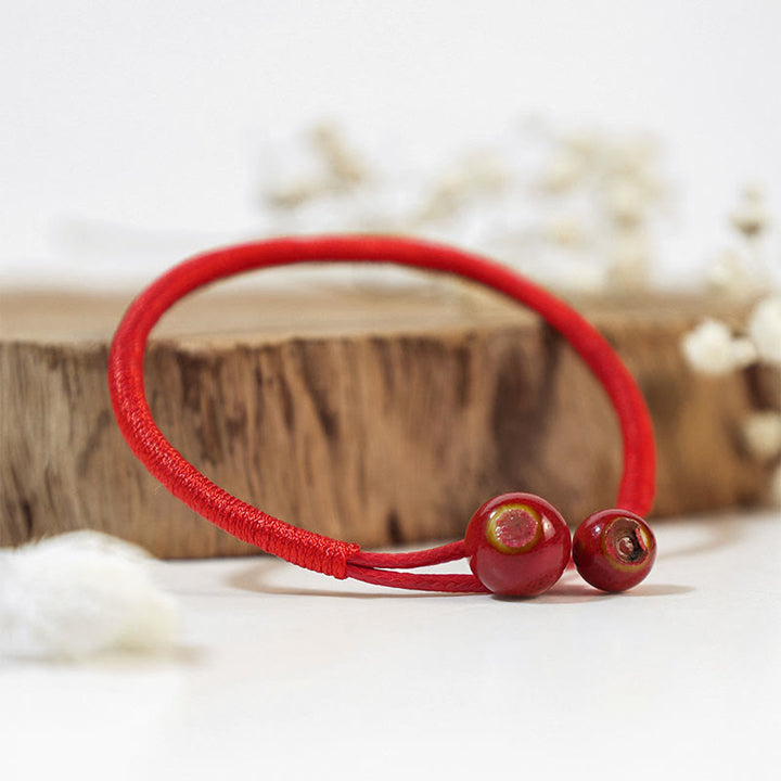 Buddha Stones ​​Feng Shui Glücksarmband aus roter Keramikschnur - image 0