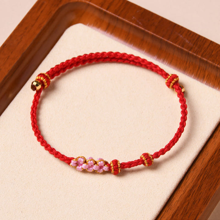 Buddha Stones Handgemachtes Pfirsichblüten-Schutzarmband aus geflochtenem Seil