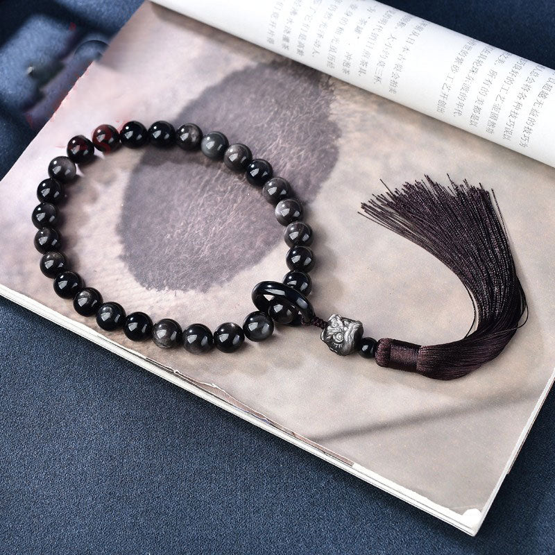 Natürlicher silberfarbener Obsidian-Löwe-Handgelenk-Mala-Schutz, Quasten, Taschen-Mala, Autodekoration