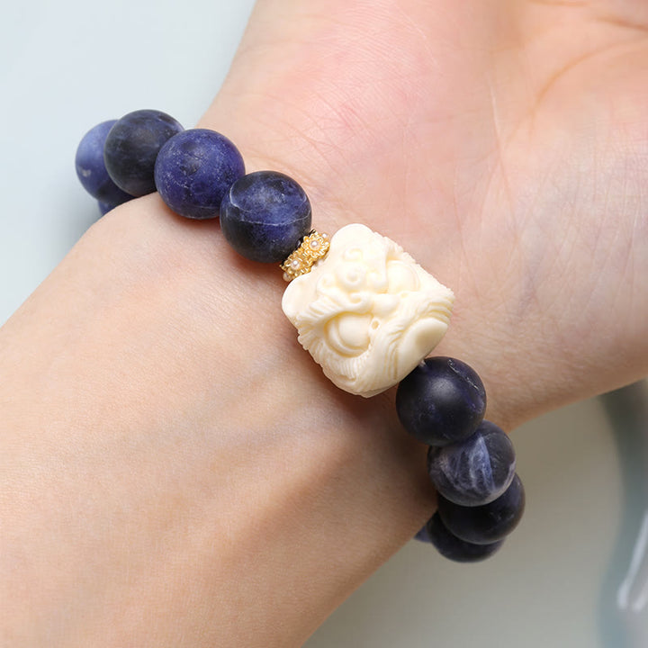 Armband mit Buddha Stonesn, Sodalith, Elfenbein, Früchten, tanzender Löwe, Halbmond, Harmonie