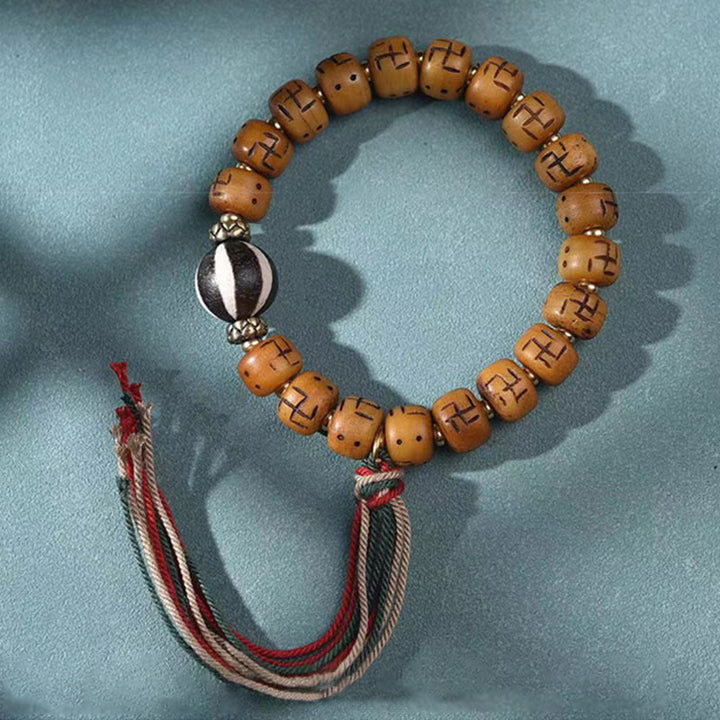 Buddha Stones, natürliches tibetisches Kamelknochen-Hakenkreuz-Dzi-Perle, Shankha-Buddha-Charm, Kirtimukha-Glücksschutz-Quastenarmband