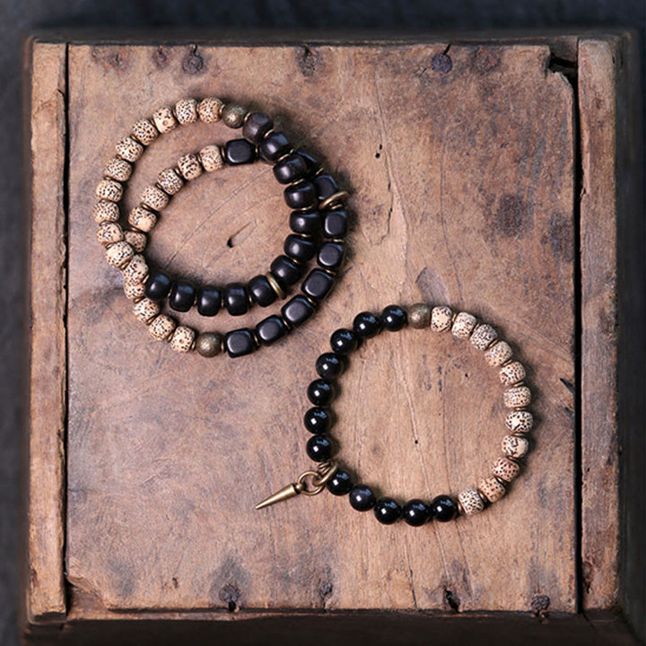 Buddha Stones Tibetischer Bodhi-Samen, schwarzer Obsidian, Ebenholz, Kupfer, Friedensarmband
