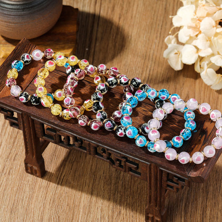 Buddha Stones Gold Schluckendes Biest Familie Rosa Liebesherz Leuchtendes fluoreszierendes Liuli-Glasperlenarmband