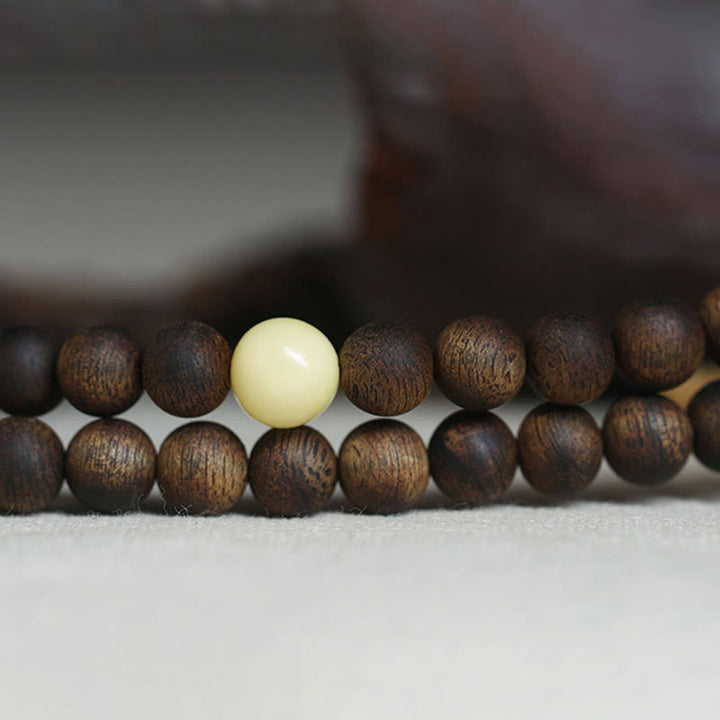 Buddha Stones 999 Gold Tarakan 108 Mala Perlen Adlerholz Bernstein Armband zur Abwehr böser Geister