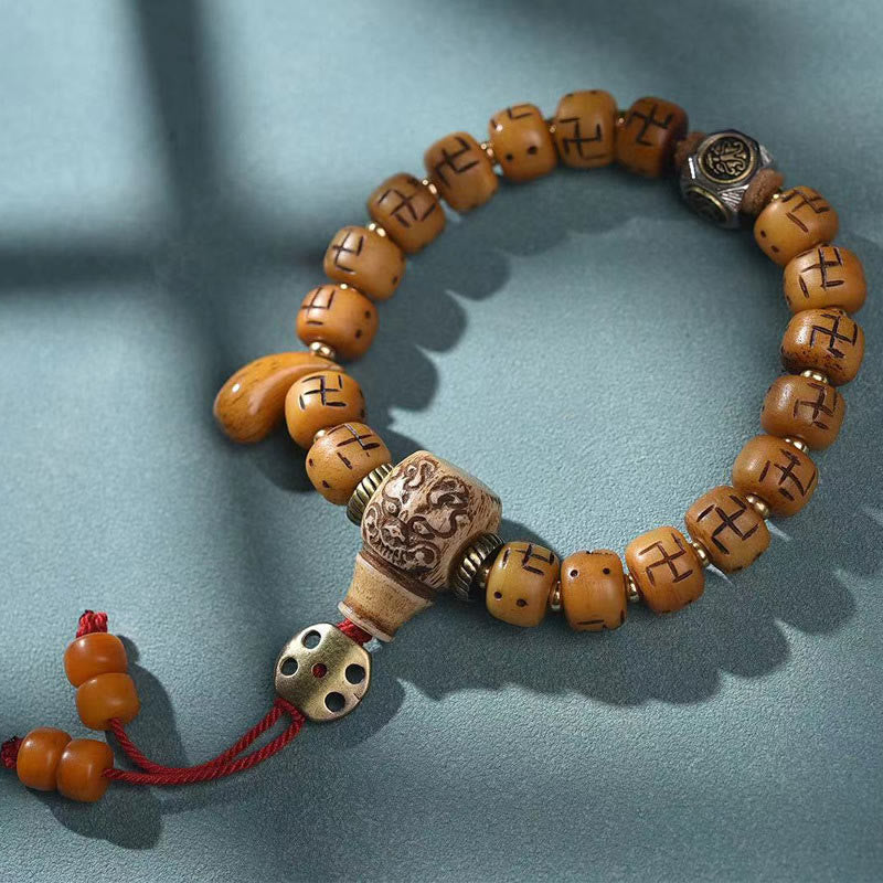 Buddha Stones, natürliches tibetisches Kamelknochen-Hakenkreuz-Dzi-Perle, Shankha-Buddha-Charm, Kirtimukha-Glücksschutz-Quastenarmband