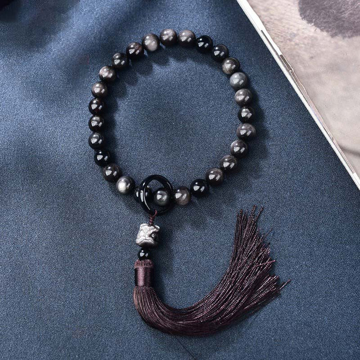 Natürlicher silberfarbener Obsidian-Löwe-Handgelenk-Mala-Schutz, Quasten, Taschen-Mala, Autodekoration